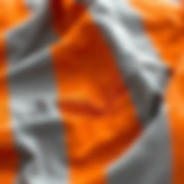 Close-up of the intricate fabric textures in an orange and grey comforter set, highlighting quality and design.