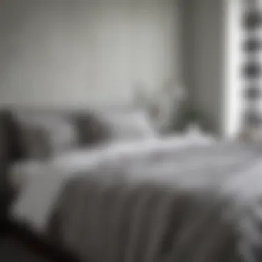 Contemporary Minimalist Bedroom with Grey Stripes Stylish grey striped bedspread on a minimalist bed